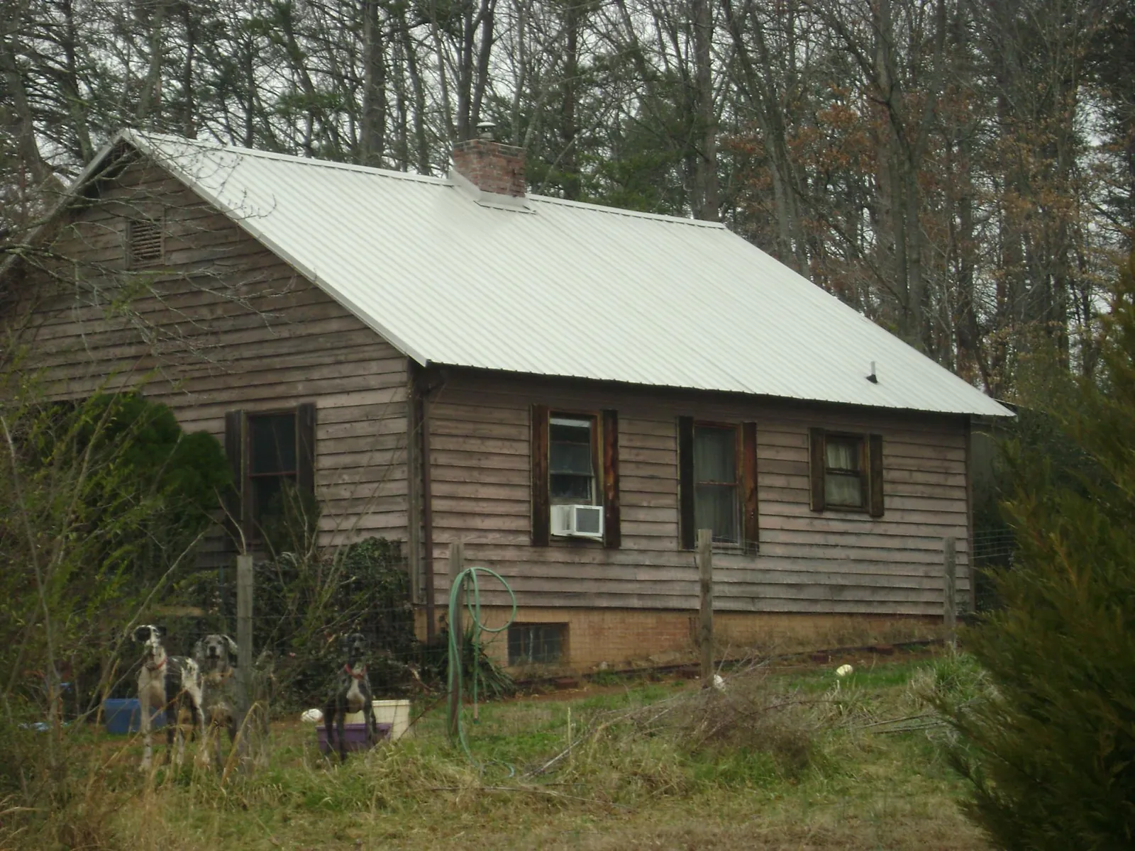 White metal roof on an old wood sided farmhouse, from a Metal Roof Installation job in Bonsall